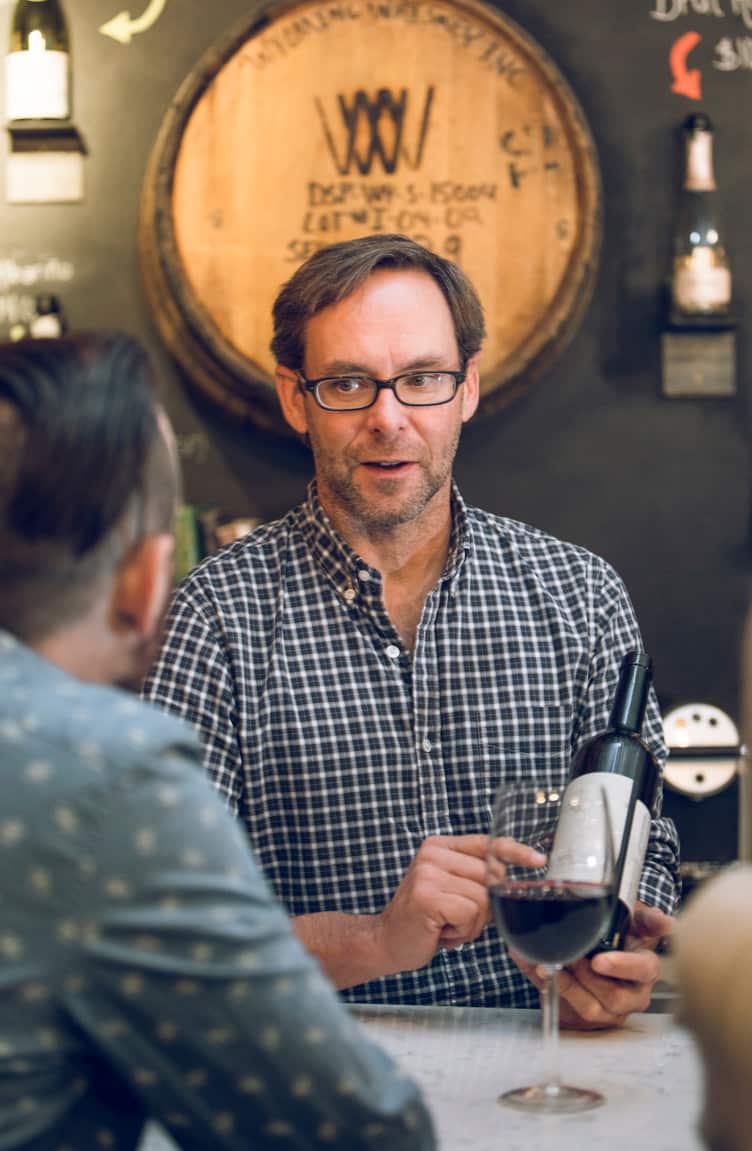 Person holding wine bottle